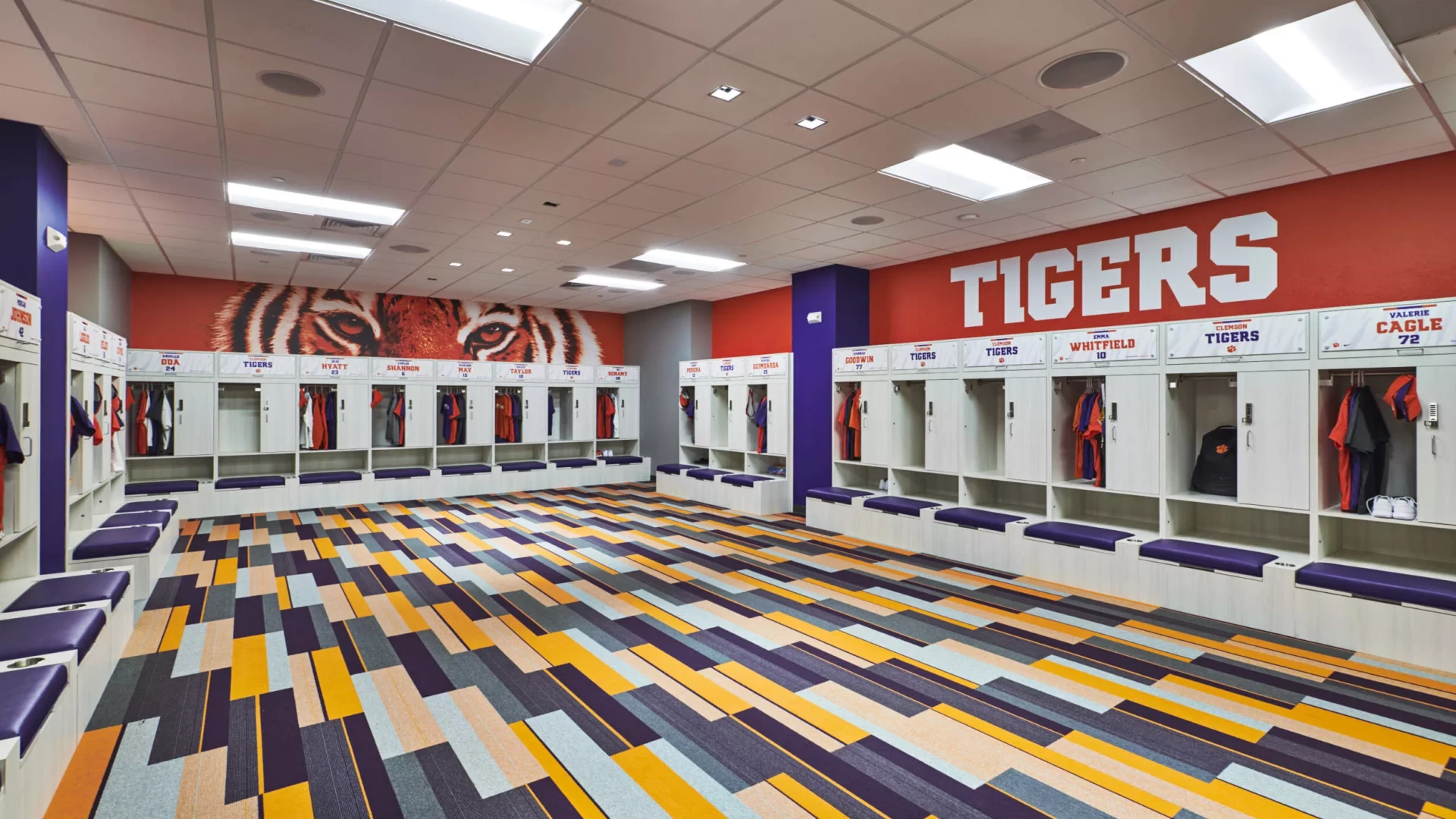Softball locker room with wall graphics and locker headers.