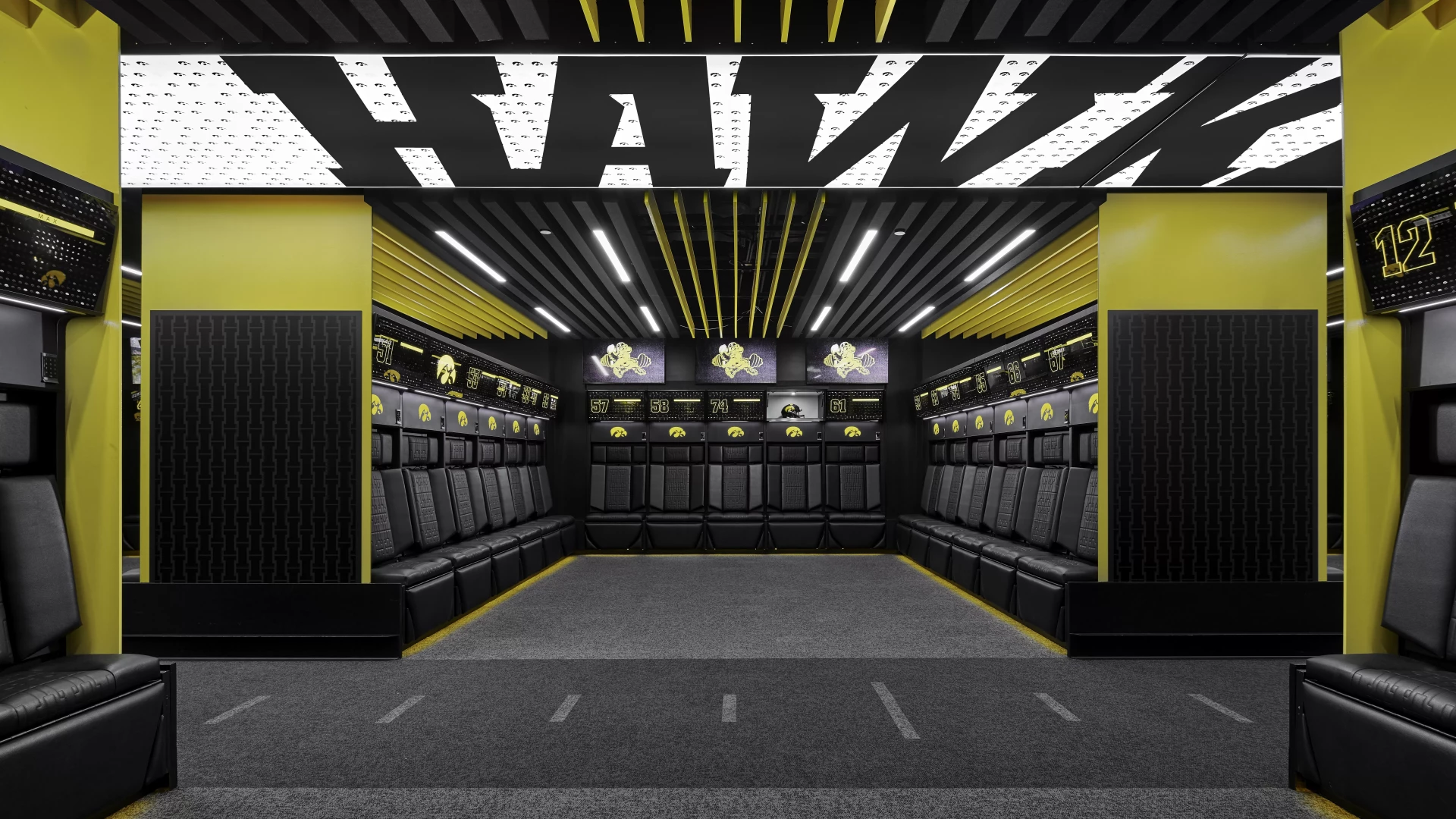 locker room with illuminated hawkeyes on top. 