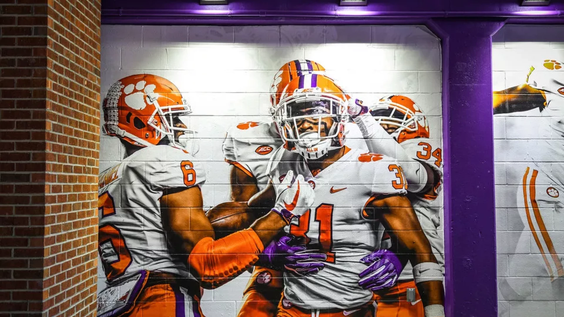 Gameday tunnel with football players wall graphic.