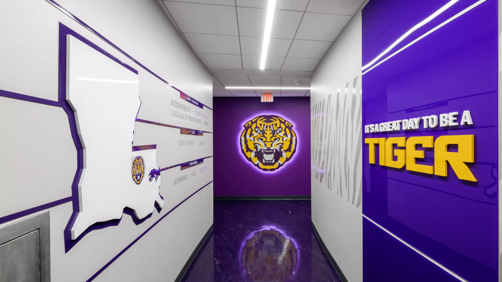 hallway with illumiated logo at the end. 