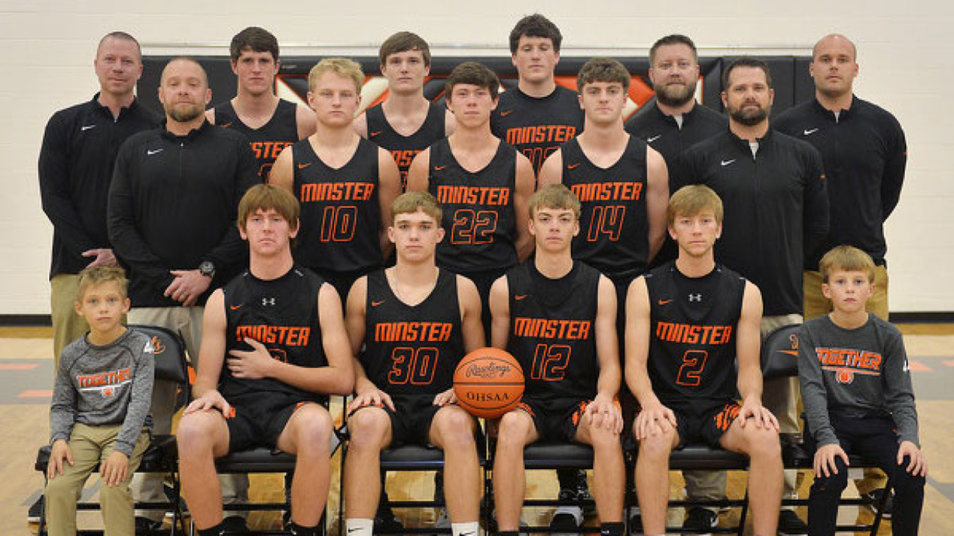 boys basketball team with two of 49 employees as coaches 