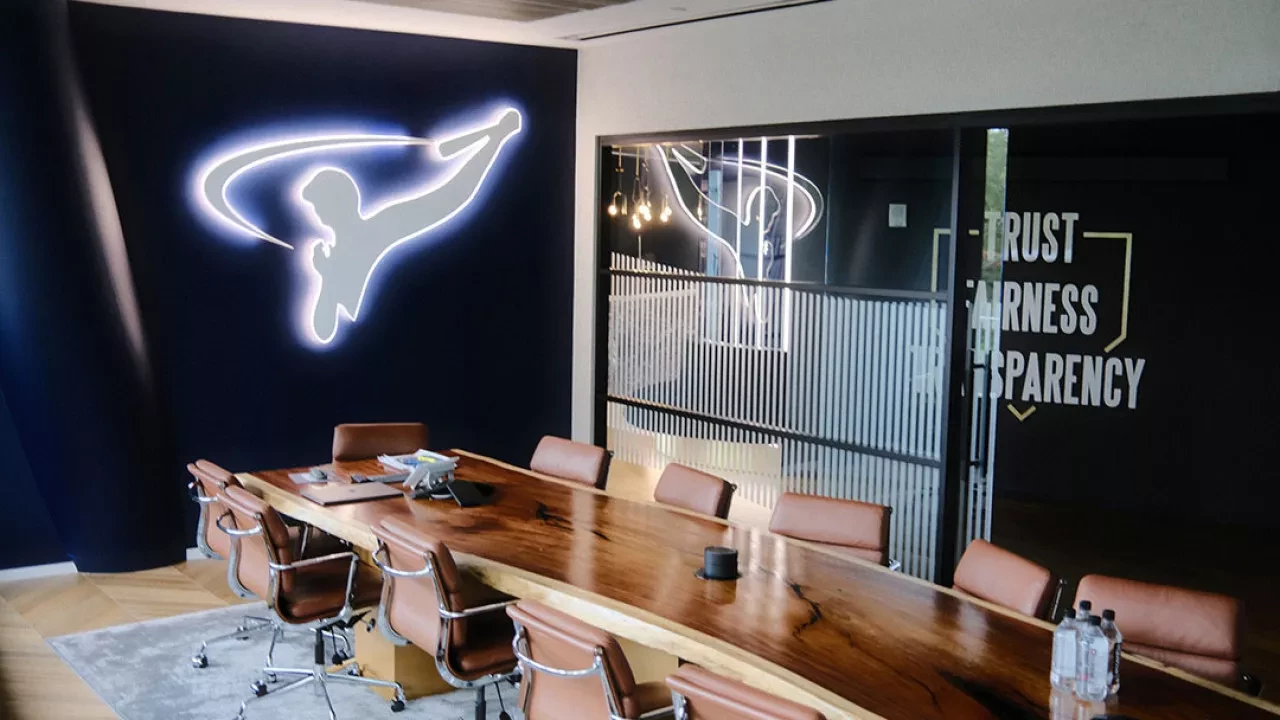 Boardroom at Arod Corp with an illuminated Arod logo on the wall