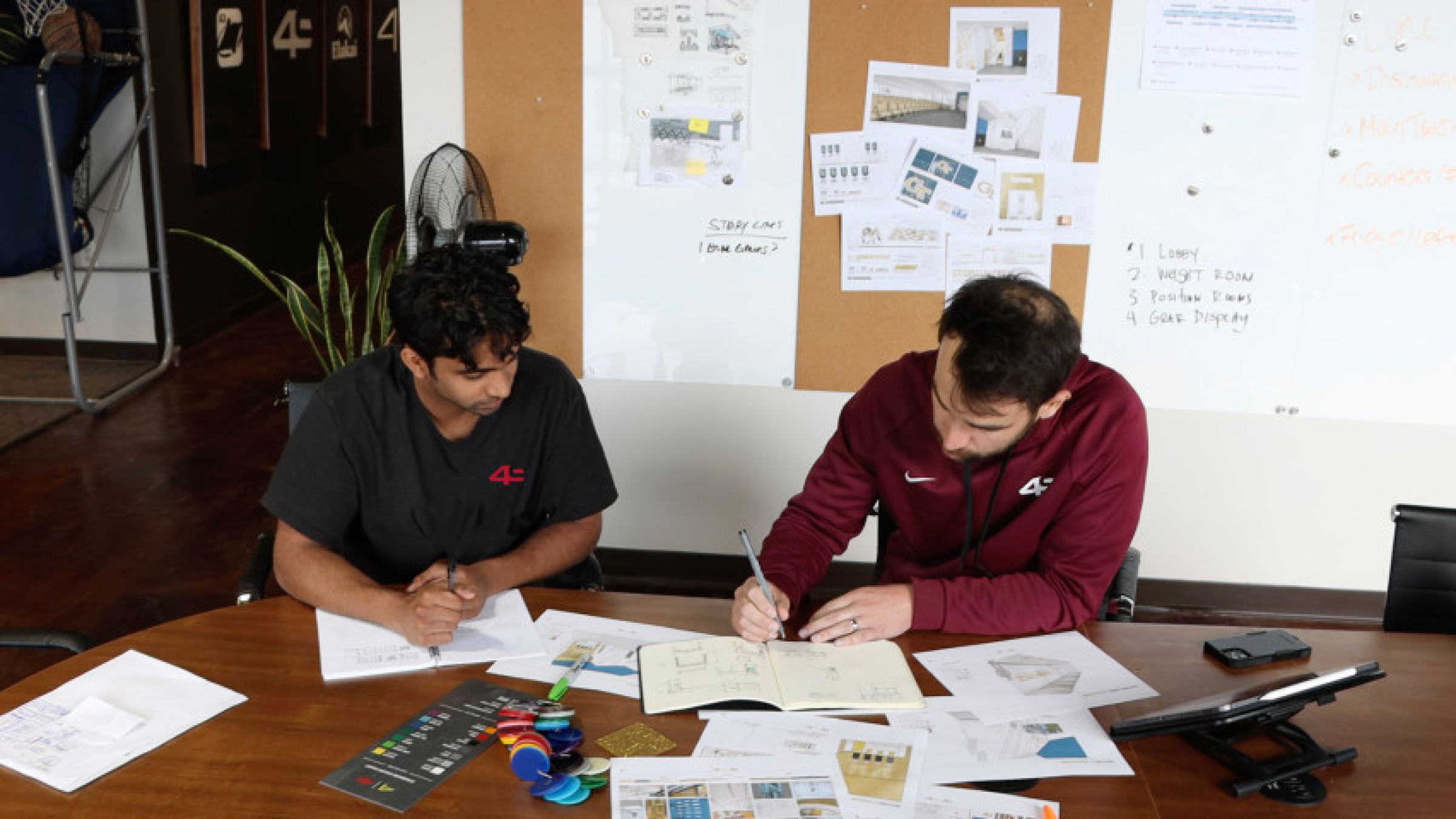 2 people collaborating on a design at a table